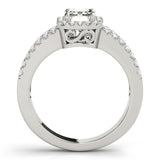 Four-Prong Halo Emerald Platinum Engagement Ring